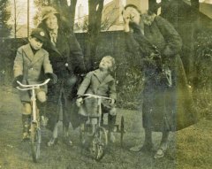 Mildred & Granny Elaine Hooke with her sons, George & John on bikes. Location unknown. Date approx. 1934.